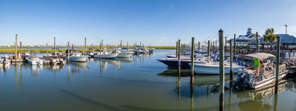 This is a panorama image of boats docked at Murrel's Inlet harbor, South Carolina