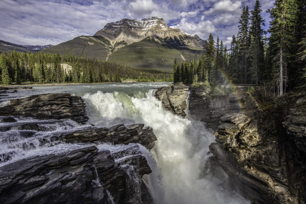 Image is a wide angle shot of the Athabasca Water Falls in the early evening.